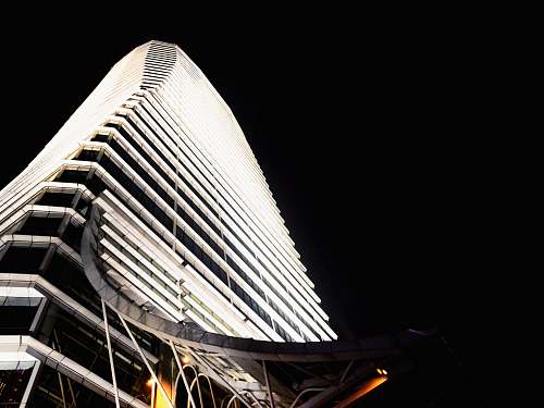 high rise low angle photography of concrete building at nighttime architecture